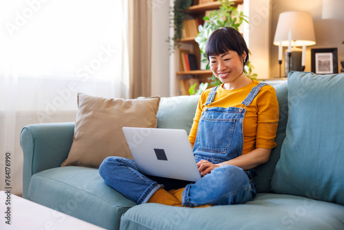 Woman working remotely from home using laptop computer