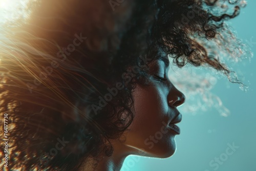 african american young female model woman shaking her beautiful afro hair in motion. ad for shampoo conditioner hair