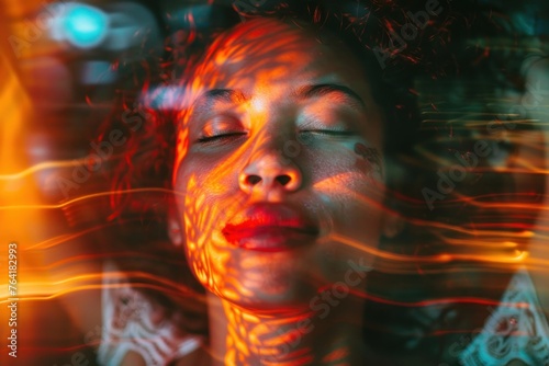 Portrait of a woman with his eyes closed and the glowing energy that passes through his body