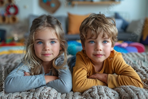 Two young siblings cuddling together under a cozy knitted blanket with a soothing atmosphere
