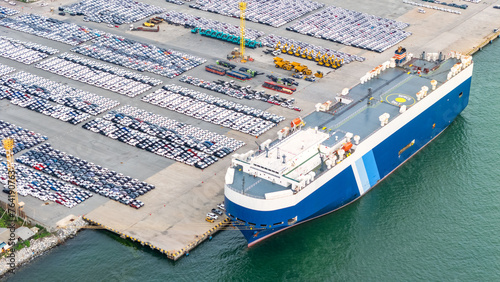 Aerial view Ro-Ro Ship of business logistic sea freight, New Cars produced by year up in the port for Cargo ship and Cargo import-export around in the world. cargo ship by tug boat
