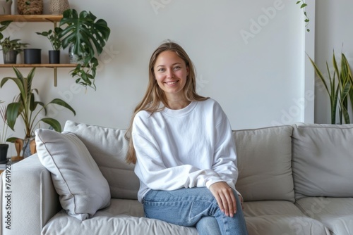 Contemplative young woman in casual wear relaxing on a cozy sofa in a modern living room, embodying a serene and thoughtful moment at home - AI generated