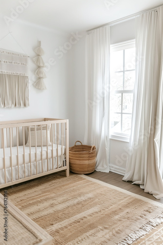 Nursery room with a light wood baby crib, woven basket, and white curtains. A beige rug on the floor with a window view of nature. A style is boho aesthetic with neutral colors and a minimalist design