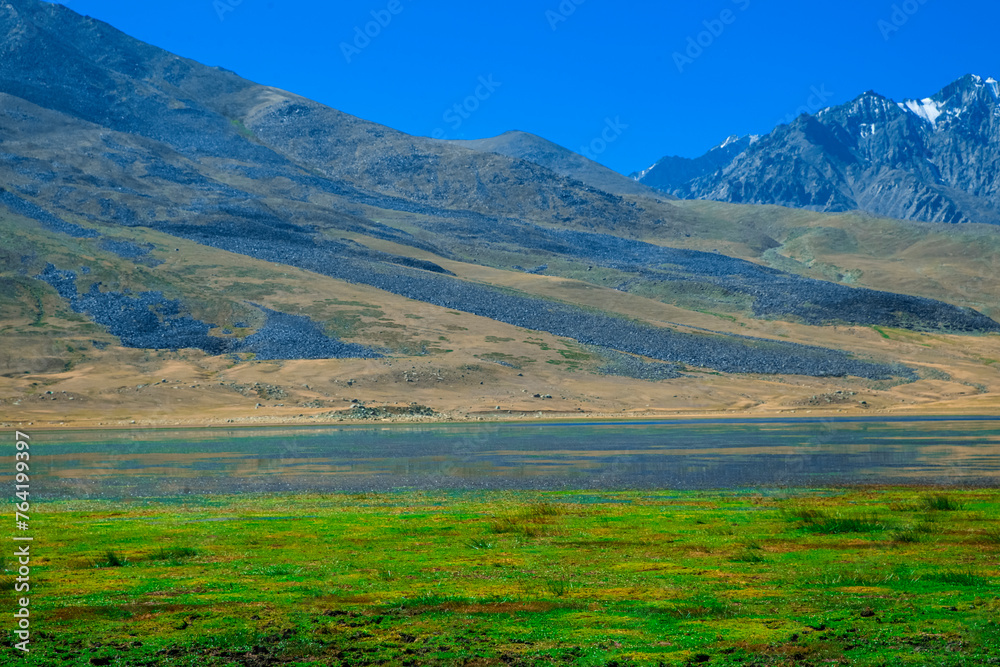 Huge mountains on green land in Ghizer valley Pakistan Huge mountains on green land in Ghizer valley Pakistan