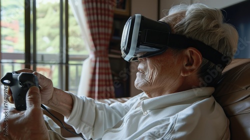 Senior retirement Asian man wearing virtual reality glasses sitting on couch sofa holding joystick