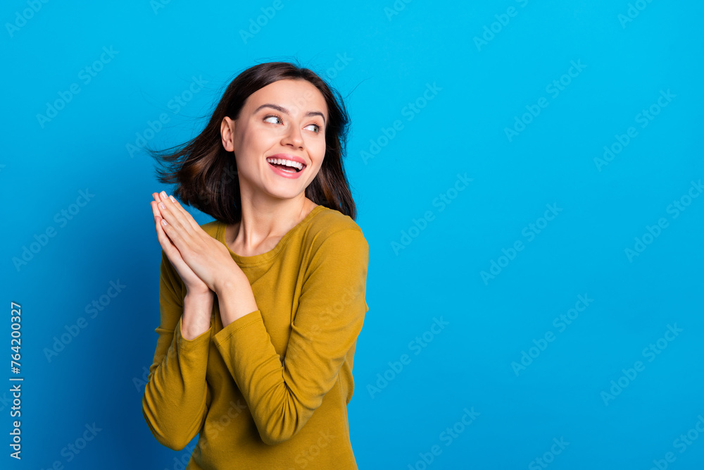 Photo of dreamy pretty woman wear shirt wind blowing looking empty space isolated blue color background Photo of dreamy pretty woman wear shirt wind blowing looking empty space isolated blue color background