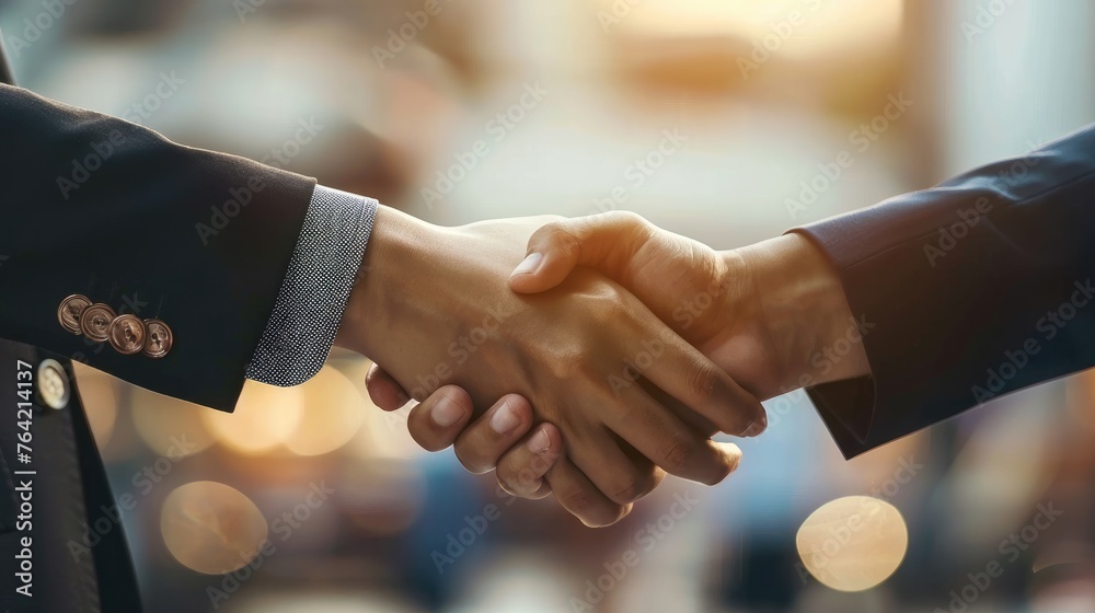 businessman and businesswoman wearing suit and shaking hands (teamwork or partnership concept) businessman and businesswoman wearing suit and shaking hands (teamwork or partnership concept)