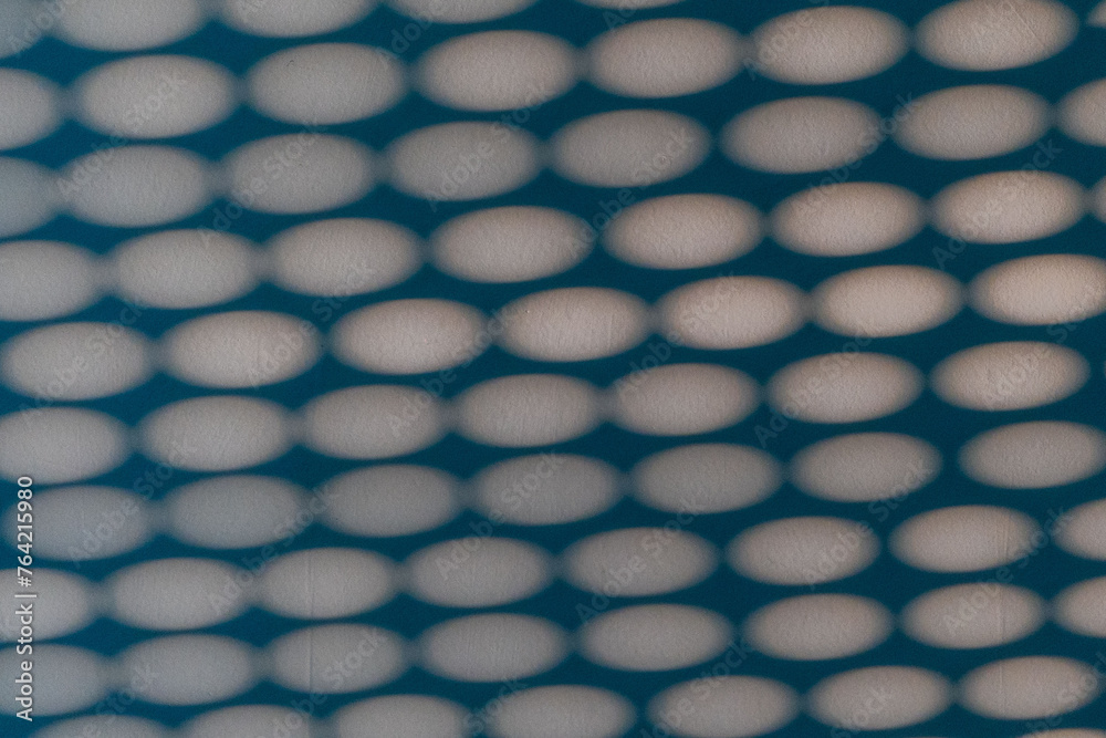 Abstract sunlit round shapes. Blinds reflection on wall. Abstract sunlit round shapes. Blinds reflection on wall.