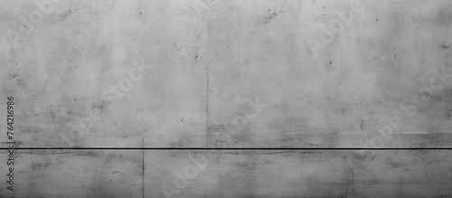 Capture a detailed view of an individual strolling along a paved sidewalk while holding a vibrant red umbrella