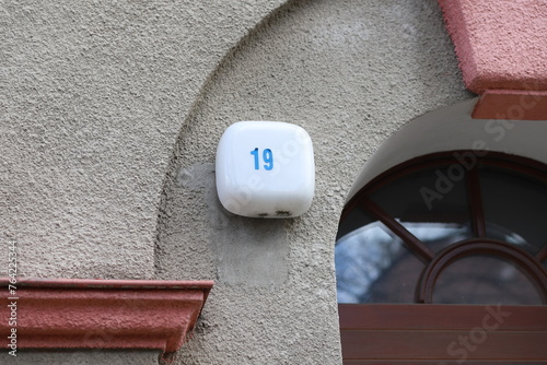 Number 19 above the entrance. House number. Number 19 on the lamp. photo