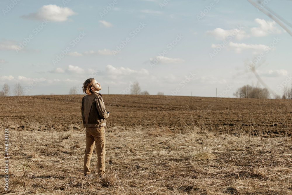 lonely man in a leather jacket in the autumn in a field in a midlife crisis experiencing depression lonely man in a leather jacket in the autumn in a field in a midlife crisis experiencing depression