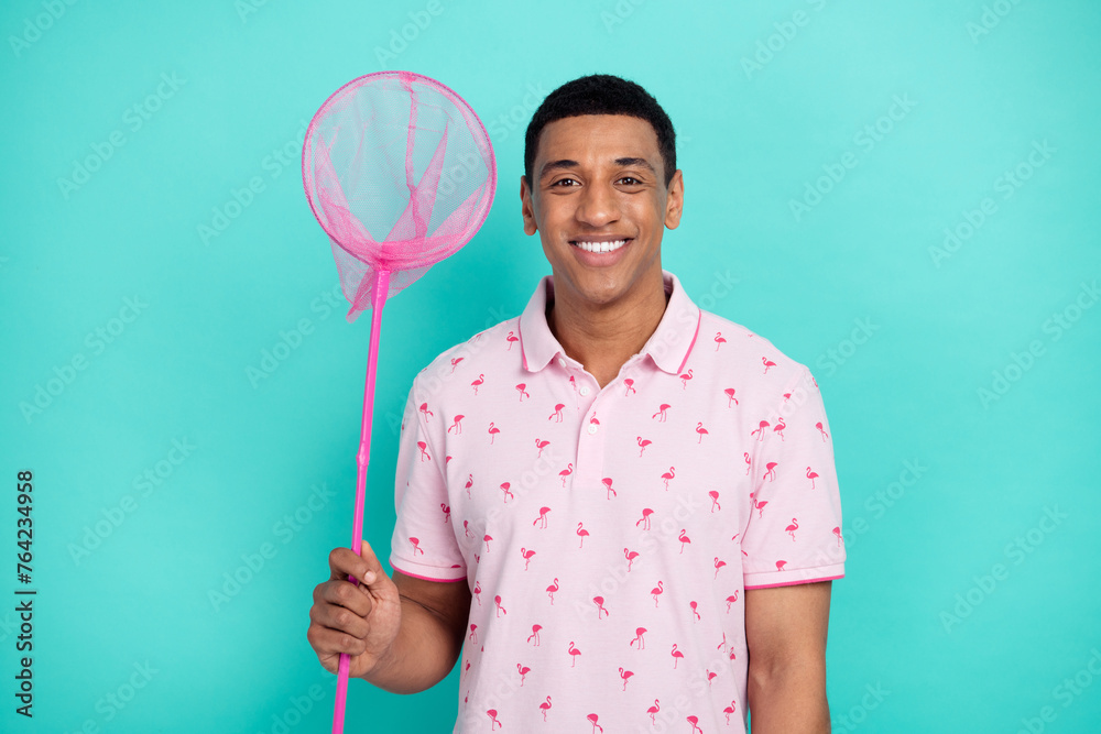 Photo of toothy beaming nice guy dressed casual polo hold butterfly net catching sales on black friday isolated on teal color background Photo of toothy beaming nice guy dressed casual polo hold butterfly net catching sales on black friday isolated on teal color background