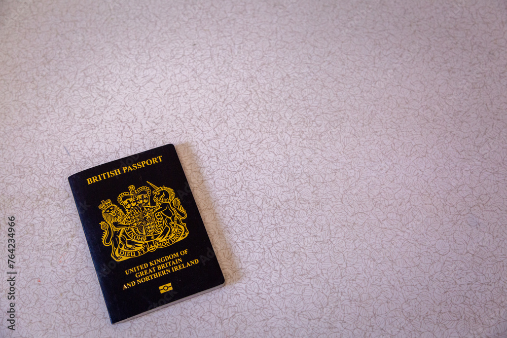 New British passport of post-Brexit blue black UK passport cover with against light background New British passport of post-Brexit blue black UK passport cover with against light background