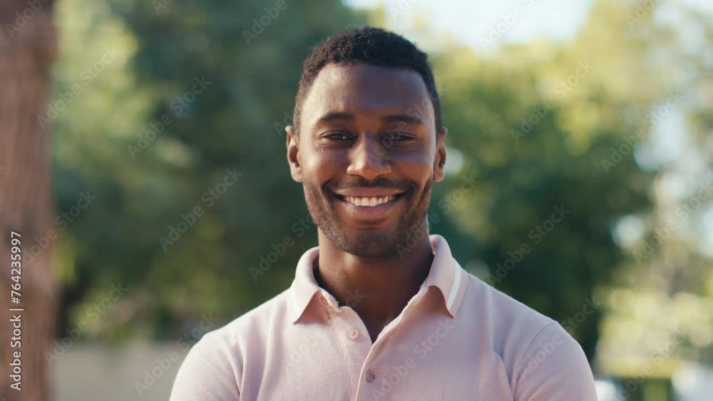 Head and shoulders shot of man standing outside in beautiful countryside smiling at camera - shot in slow motion