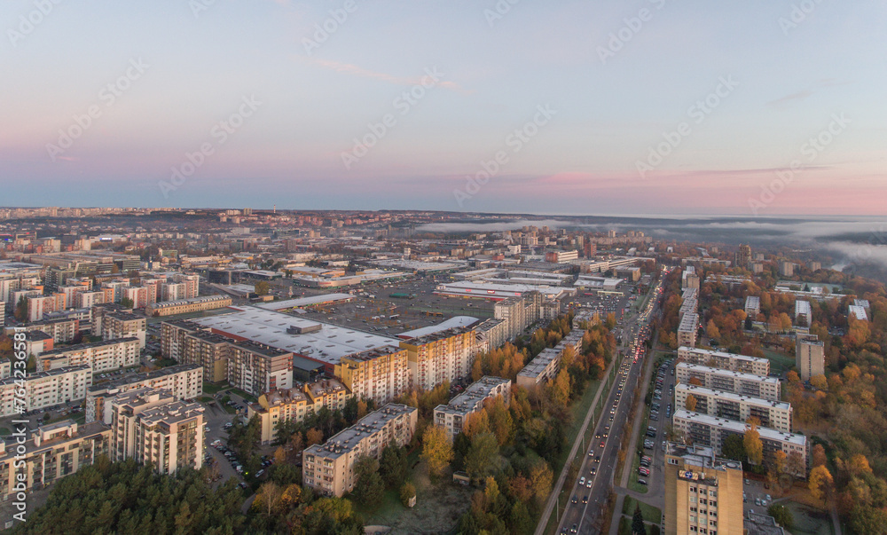 Obraz premium Zirmunai District in Vilnius City, Lithuania. Morning Traffic. Autumn Leaves Color. Morning Golden Hour Light.