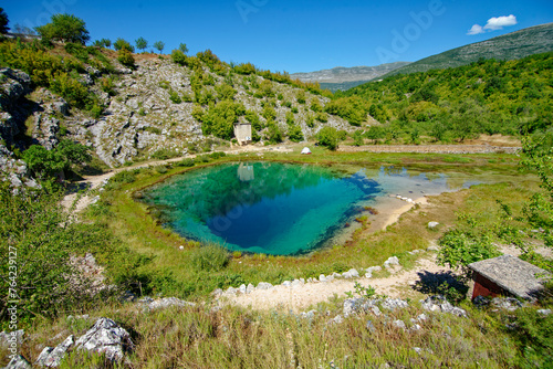 The Eye of the Earth, Croatia Cetina River Source. Church in the background. Rural tourism and travel destinations.