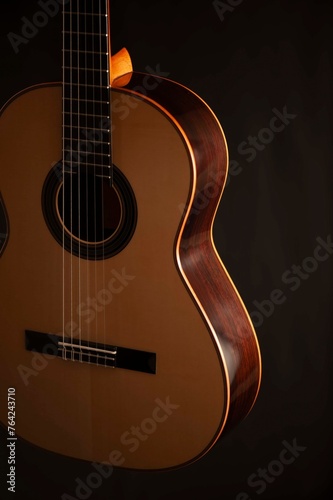 Classical Spanish flamenco guitar close up, dramatically lit isolated on black background with copy space.