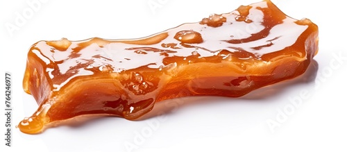 Obraz na płótnie A translucent gelatin slice on a white surface