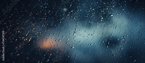 Raindrops on window against sky background
