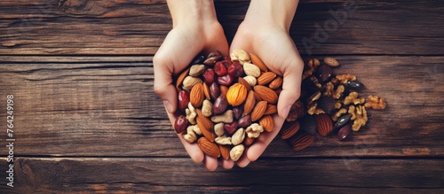 Person holding a handful of assorted nuts
