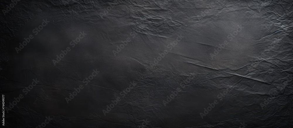 Black textured paper background with a dark backdrop