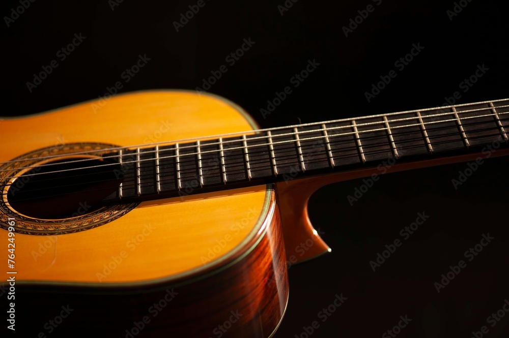 Classical Spanish flamenco guitar close up, dramatically lit isolated on black background with copy space. Classical Spanish flamenco guitar close up, dramatically lit isolated on black background with copy space.