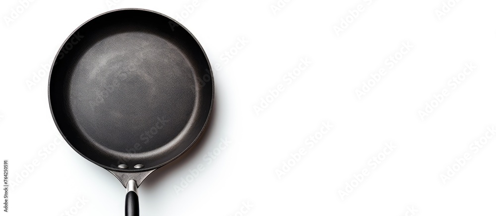 Close up of frying pan on white surface Close up of frying pan on white surface