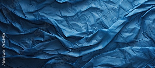 Blue wrinkled paper texture close-up © Ilgun