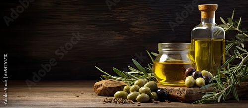 Olives and olive oil on wooden table with rosemary