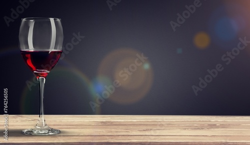 Red wine in glass on wooden desk