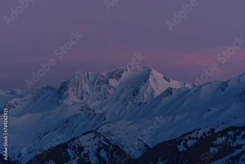 As dusk falls  the fading sunlight kisses the alpine peaks  and the rising moon adds a magical touch to the captivating mountain scenery.