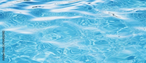 A close-up view of a serene pool displaying soothing blue water with subtle ripples on the surface