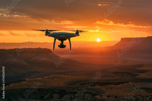 A large white and black drone is flying over a mountain with the sun setting in the background