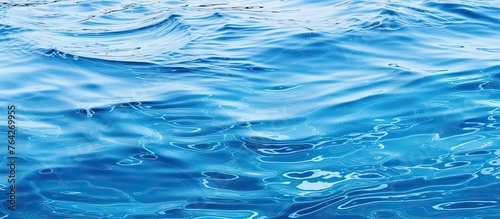 A detailed view of the deep blue sea with foamy waves breaking and bubbles forming on the surface