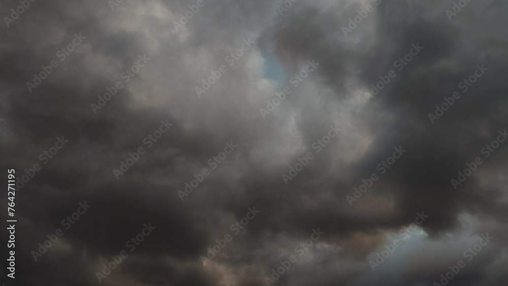 Dark curious cloud mixed with orange moving at twilight Dark curious cloud mixed with orange moving at twilight