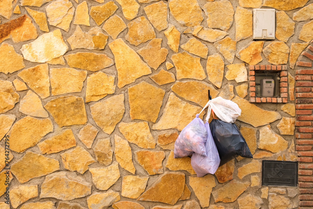 Garbage bags hanging on the doors of rural houses in villages in the Priorat of Tarragona. Garbage bags hanging on the doors of rural houses in villages in the Priorat of Tarragona.