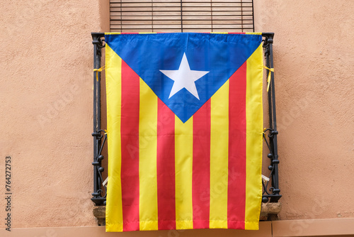Estelada Vermella, Catalan nationalist flag, placed on balconies of a town in the interior of Tarragona. photo
