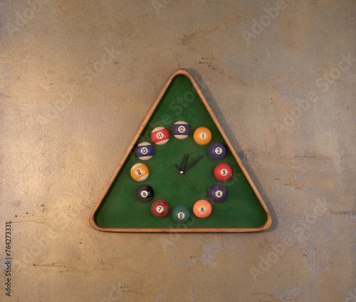 clock with billiards on an old wall
