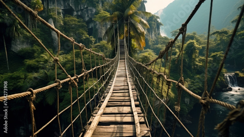 Old hanging bridge in tropical forest, vintage suspension wood path in dark jungle. Concept of travel, journey, lost, nature, adventure movie and wanderlust