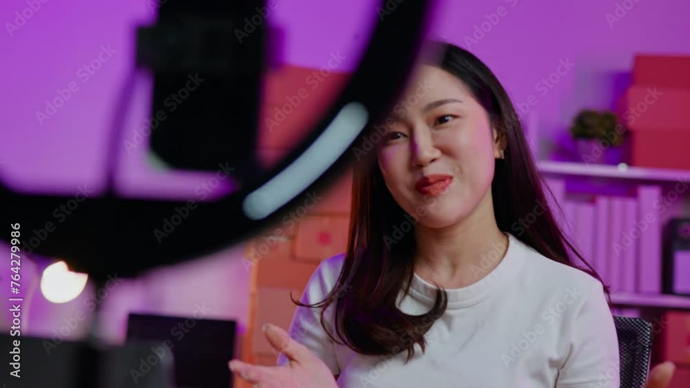 FPV view of online seller is live streaming broadcast for selling  new clothes in and receiving the orders from customer via smartphone and laptop on shopping online application.