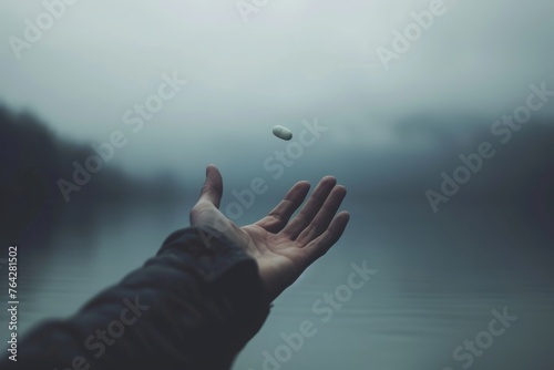 A hand reaches out towards a flying object in the sky, capturing a moment of anticipation and excitement, A distressed person reaching out for a floating opioid pill, AI Generated