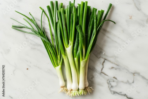 Fresh Green Onions on White Marble, Overhead View