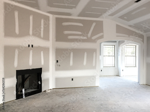 Drywall and taping interior of house construction