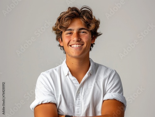 Portrait of handsome smiling young man with folded arms isolated  photo