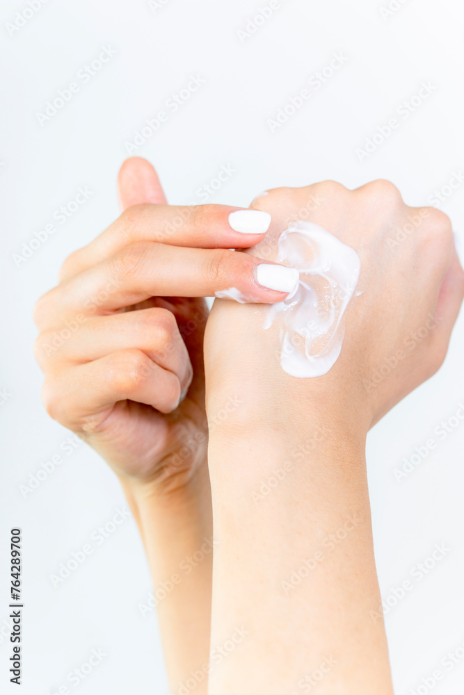 Beautiful Woman Hands. Female Hands Applying Cream, Lotion. Spa and Manicure concept. Female hands with french manicure. Soft skin, skincare concept. Hand Skin Care Beautiful Woman Hands. Female Hands Applying Cream, Lotion. Spa and Manicure concept. Female hands with french manicure. Soft skin, skincare concept. Hand Skin Care