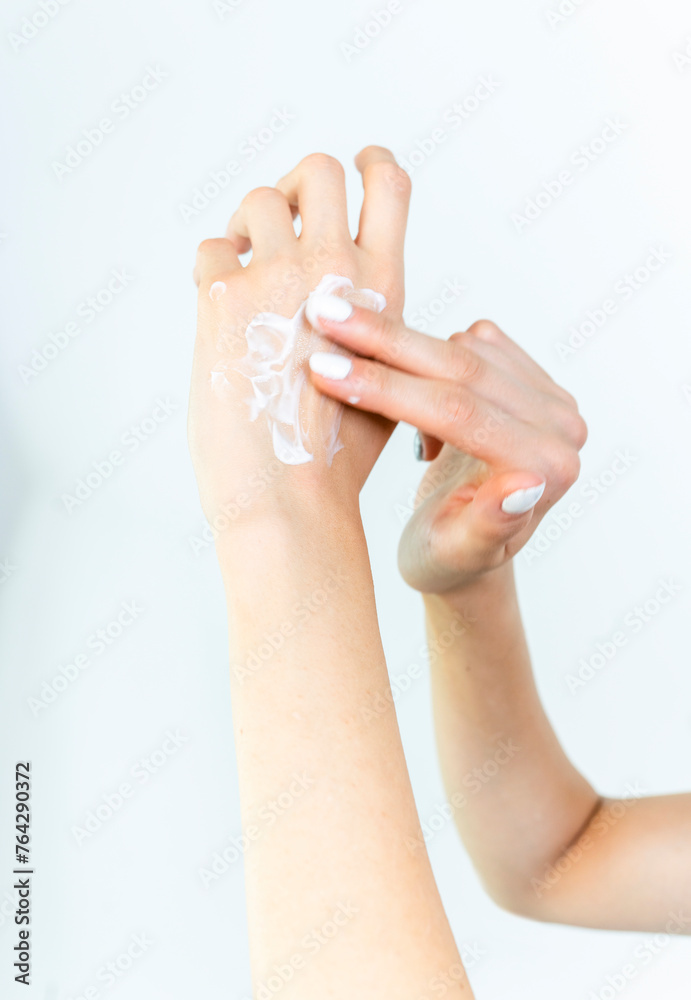 Beautiful Woman Hands. Female Hands Applying Cream, Lotion. Spa and Manicure concept. Female hands with french manicure. Soft skin, skincare concept. Hand Skin Care