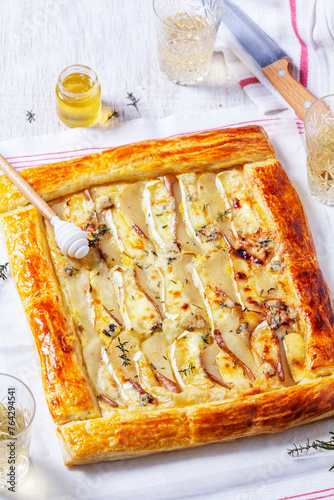 Puff pastry pie with cheese, pears, nuts and honey, served with champagne.