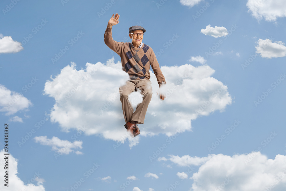 Obraz premium Male pensioner sitting on a cloud and waving