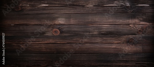 An image featuring a close-up of a wooden surface that has been stained dark brown