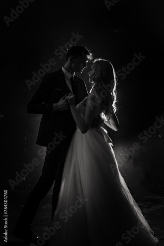 Art fashion studio photo of wedding couple silhouette groom and bride on colors background.